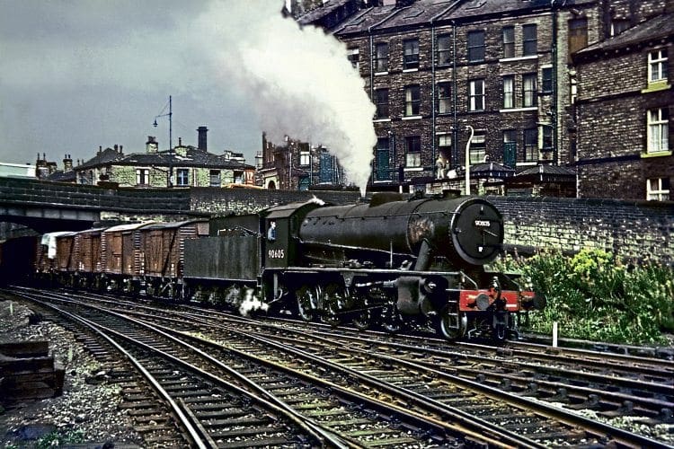Royston-based WD Austerity 2-8-0 No. 90605, one of the last locomotives to be overhauled at Cowlairs, heads an eastbound freight into Shipley on August 31, 1966. DAVE RODGERS