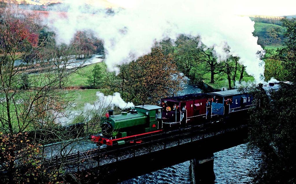 It was appropriate that the first steam locomotive to be purchased for the ELR, former North West Gas Board 0-4-0 No. 1, should be charged with hauling the
 first works trains through to Rawtenstall on November 5, 1989. The locomotive is seen hauling a pair of brake vans and Austerity 0-6-0 No. 8 Sir Robert Peel assisting the train over Alderbottom No. 2 Bridge heading towards Rawtenstall with the second train of the day. Photo: Dave Dyson