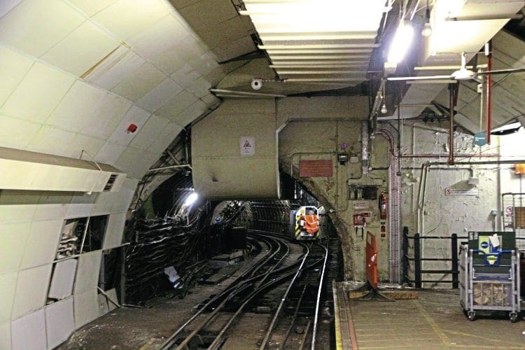 A February 2016 tunnel view with a contractor's loco in the distance. One of the Mail Rail ‘Mini York’ containers is on the platform the right.