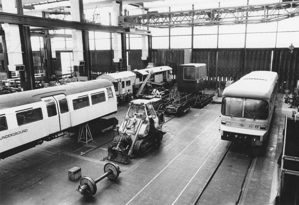 Pacer main image Black and white image of a warehouse with various train carriages.
