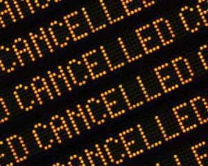 A Close Up Of The Word Cancelled Repeated Multiple Times On A Sign At A Station Or Airport