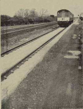 British Railways experimental paved track at Radcliffe-on-Trent: a two-car d.m.u. to Nottingham traverses the “direct laying” track