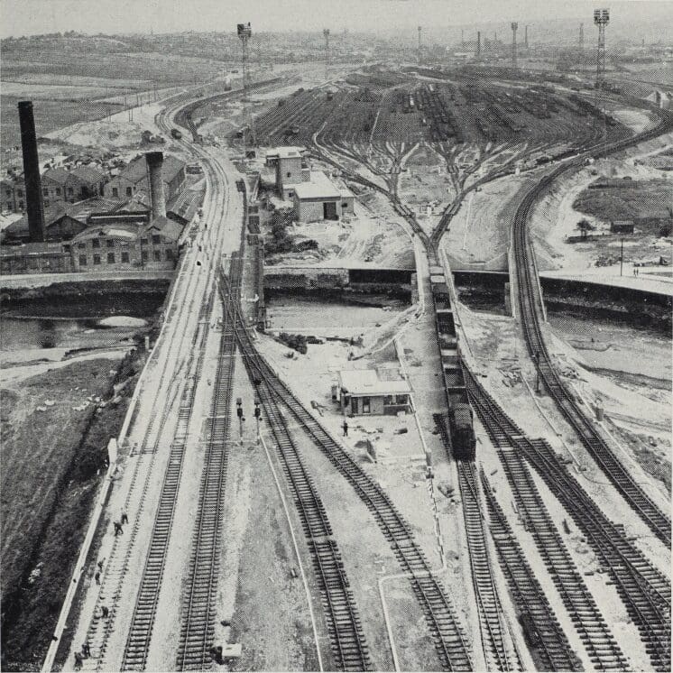 A general view of Healey Mills marshalling yard when nearing completion, showing the three new bridges over the River Calder, the hump cabin (foreground) and, on the opposite bank of the river, the compressor house, primary retarders (right) and control tower.